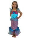 Girl with her hands on her hips wearing blue and pink mermaid dress.