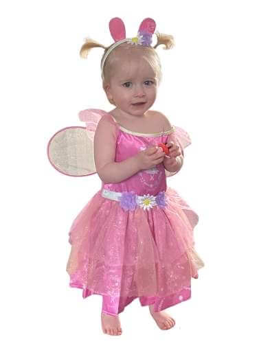 Toddler girl wearing pink Peppa Pig fairy dress with Peppa ears headband.