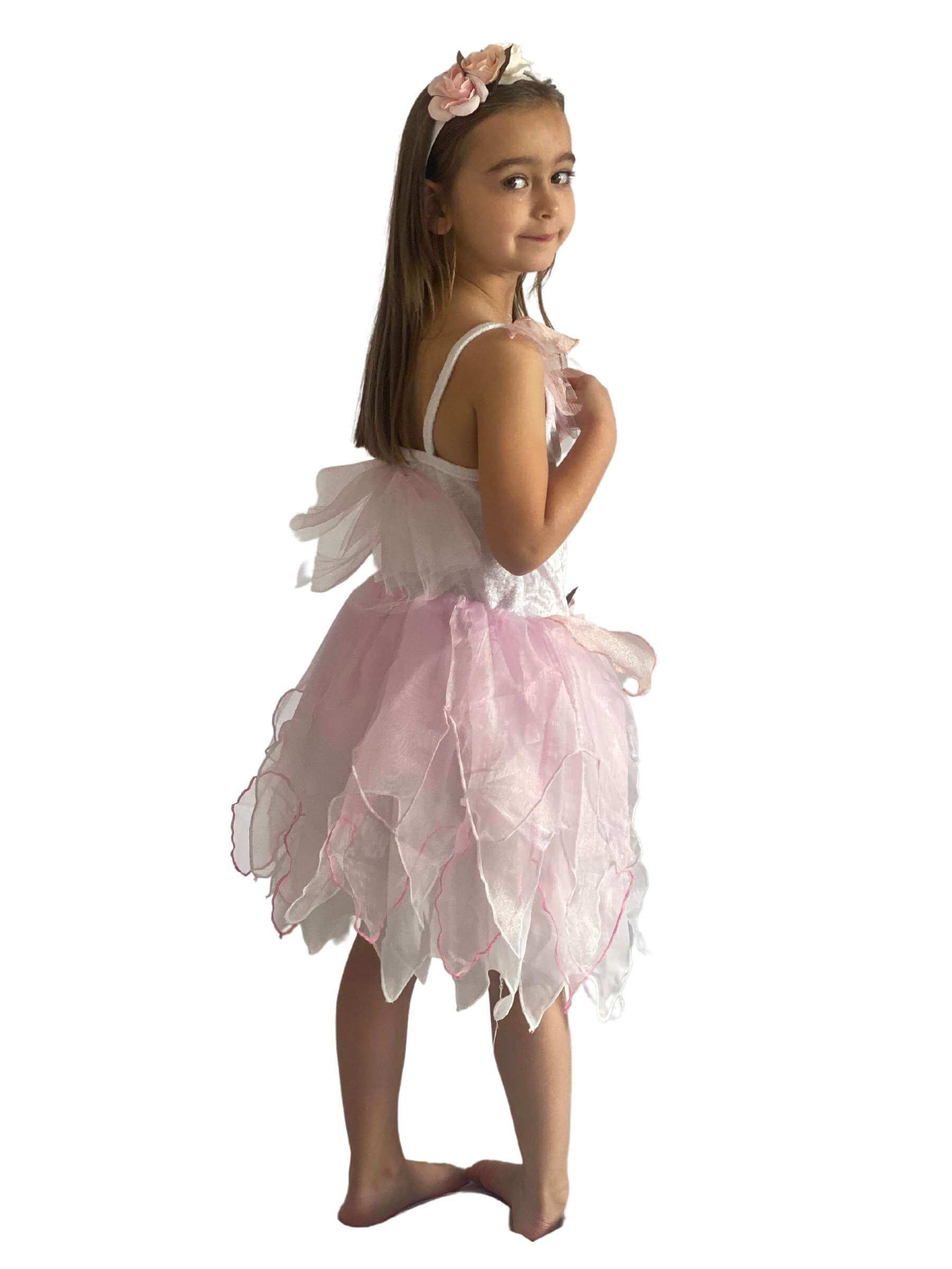 Side of the girl wearing the white and pink fairy costume showing the layered skirt and the flowers on the headband.