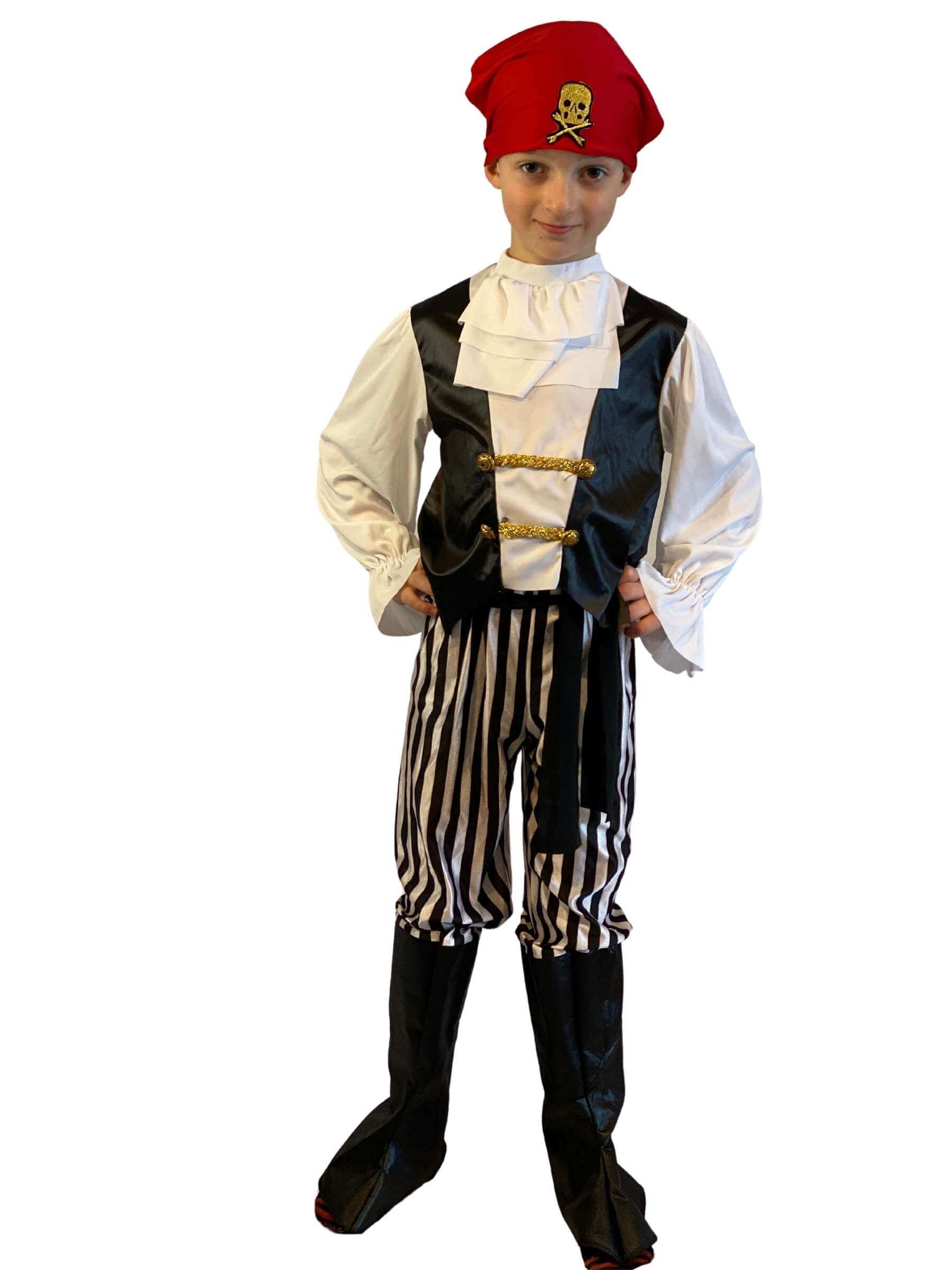 Boy wearing a black and white pirate costume with ruffled neck, black and white vertical striped trousers with attached boot covers and a red bandana.