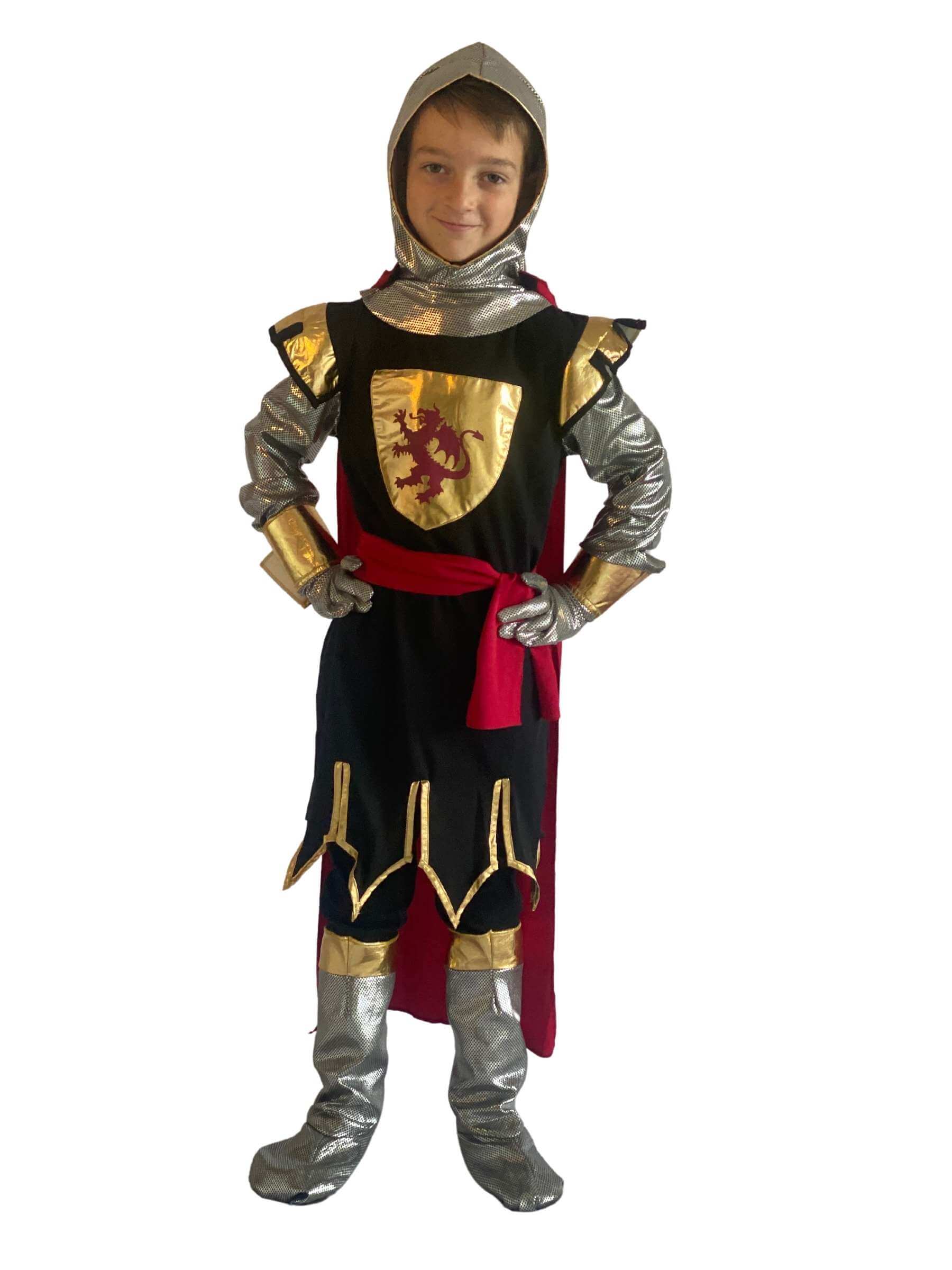 Boy wearing a a knight costume which has a black body with silver arms, hood and boot covers. The costume has gold trims and a gold crest to the centre.