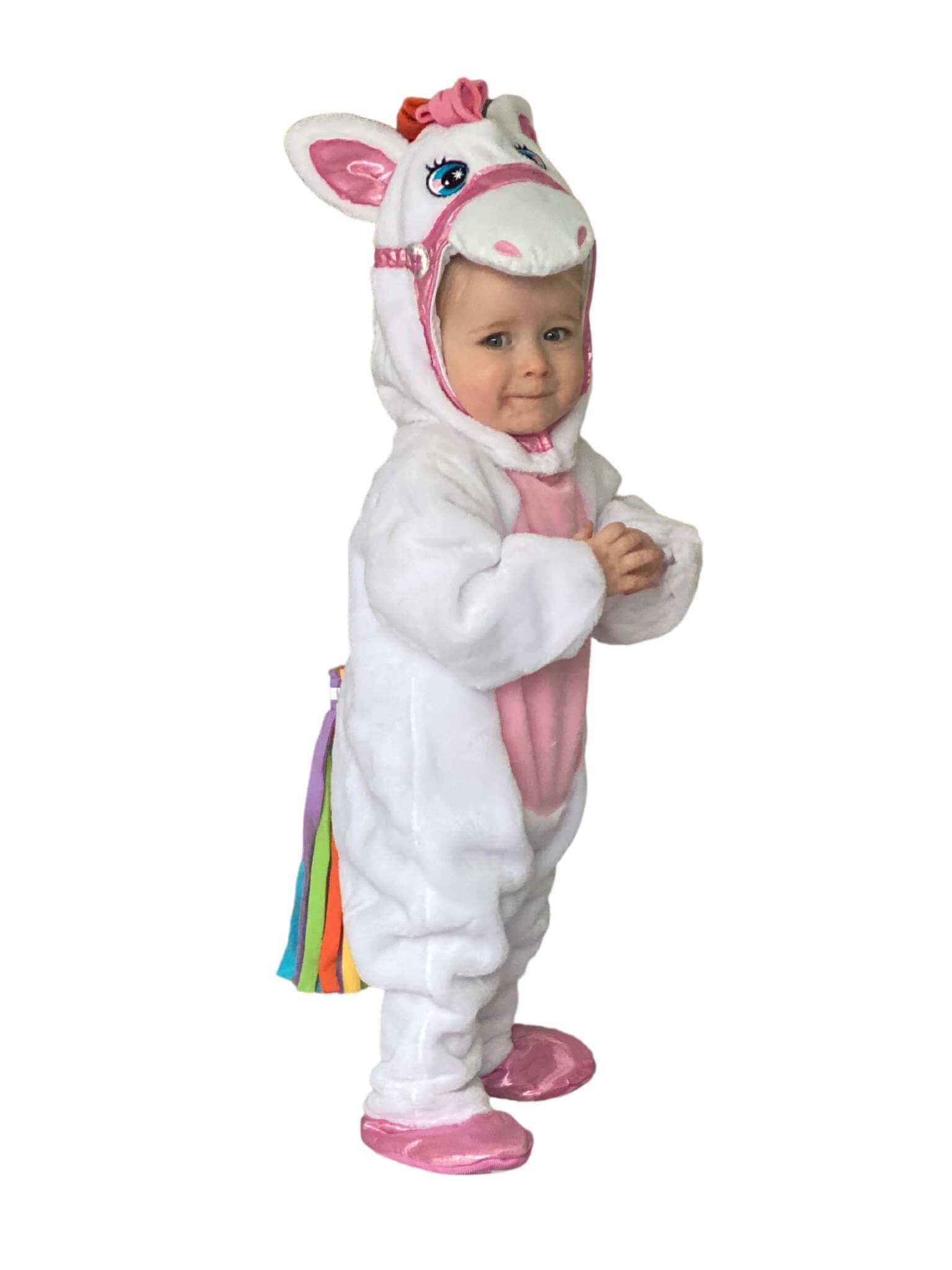 Side view of the toddler in the unicorn costume showing the colourful tail.