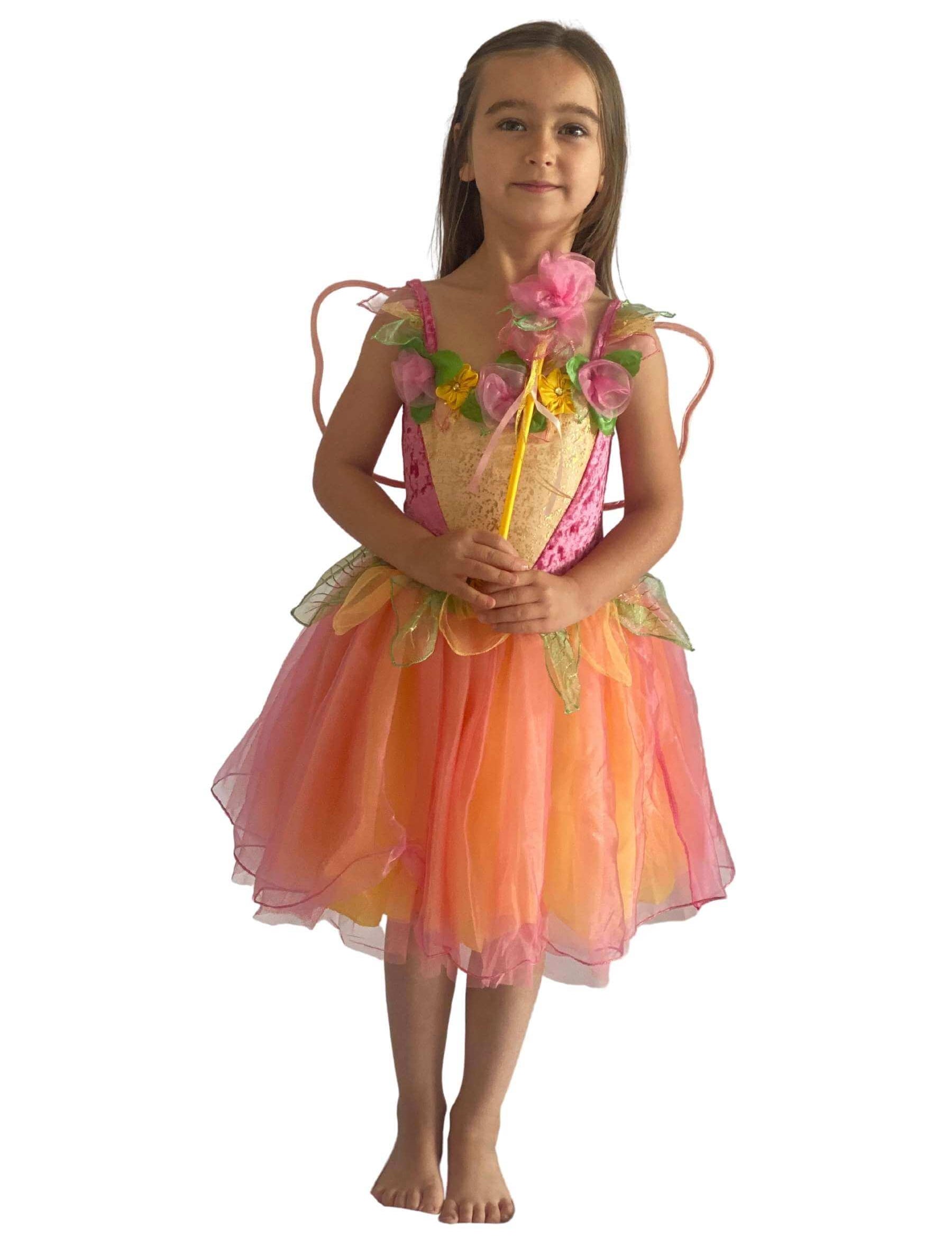 Girl wearing a pink and yellow fairy costume holding a wand.