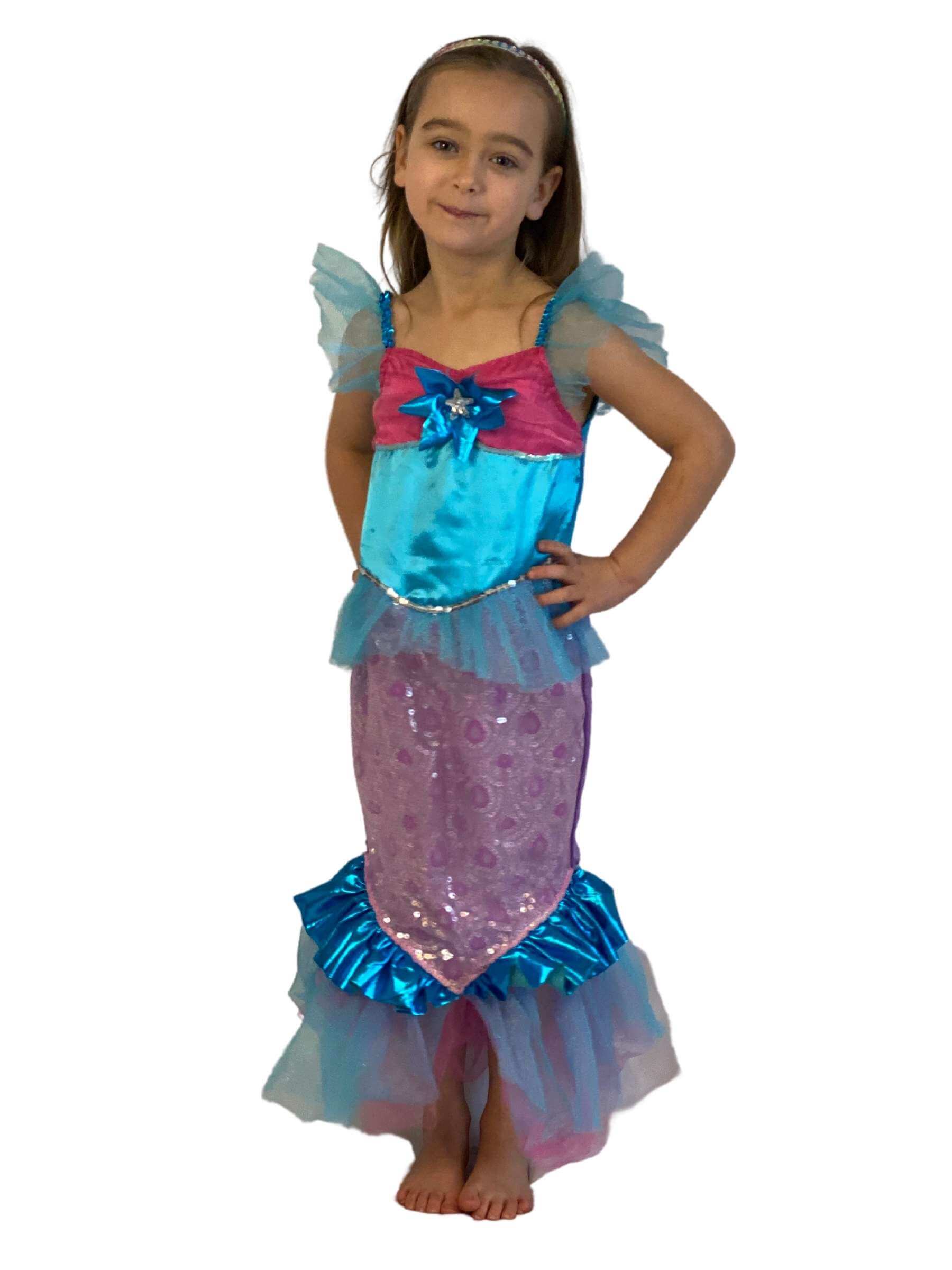 Girl with her hands on her hips wearing blue and pink mermaid dress.